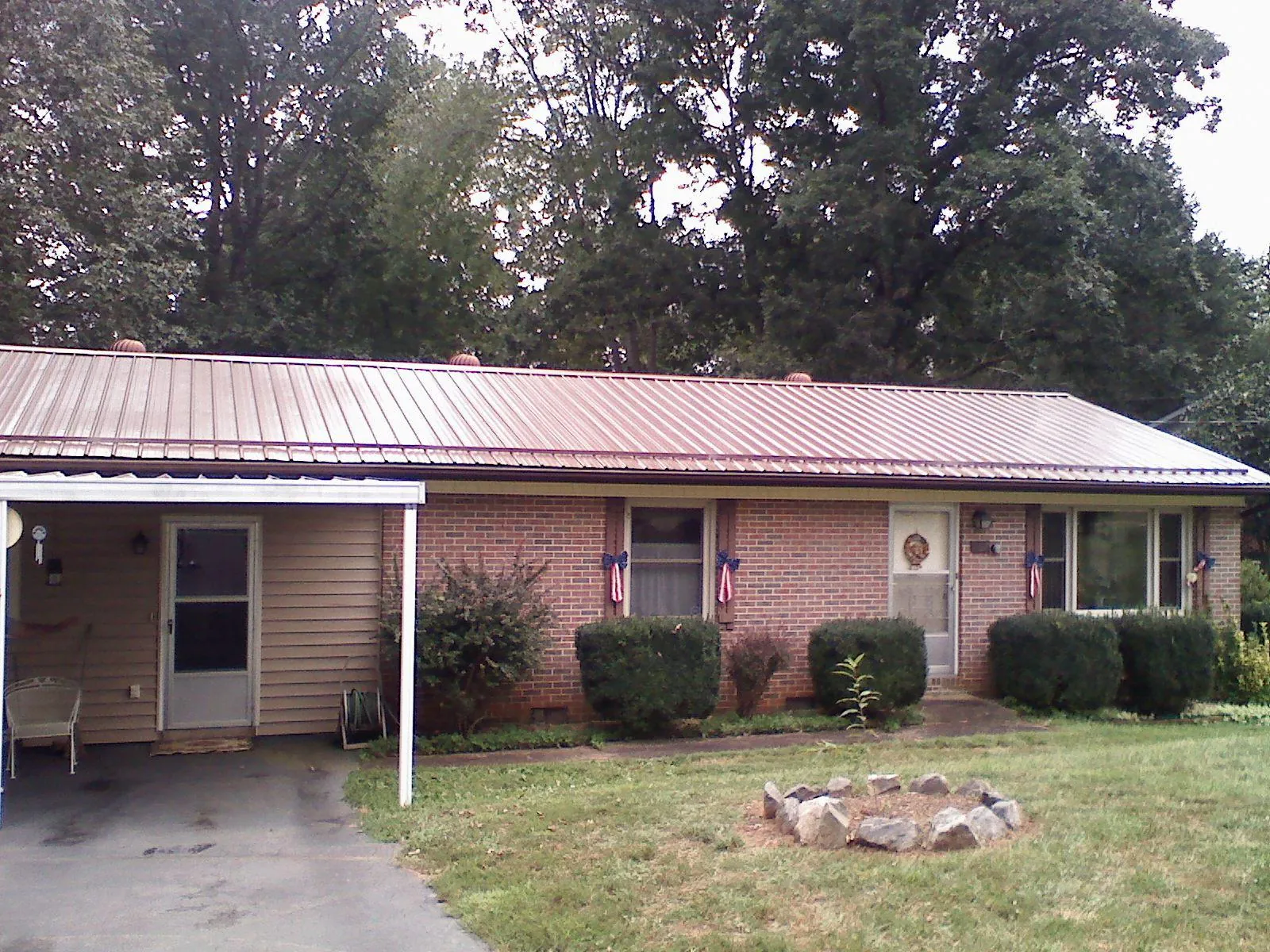 Bronze metal roof and carport on a brick ranch home — Roof Repair work by our crew in Valley Grove